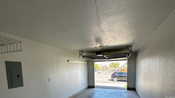 a view of a refrigerator in kitchen and an empty room
