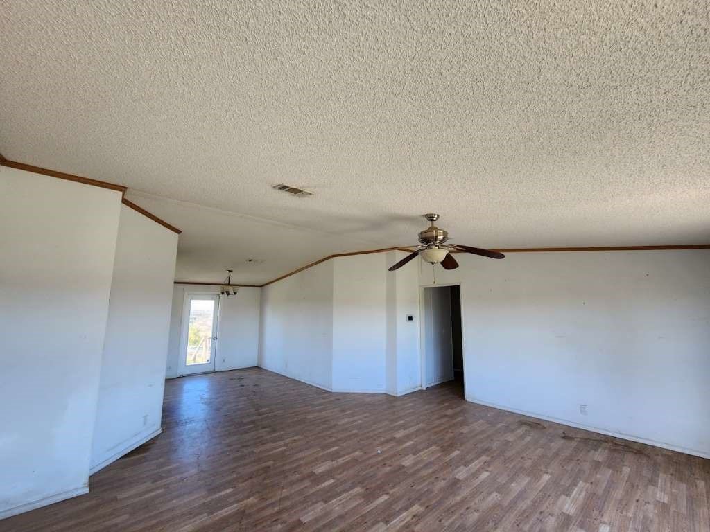 7640 Wd Court Lipan, TX 76462 - Photo 7 of 12 a view of a livingroom with a ceiling fan and wooden floor