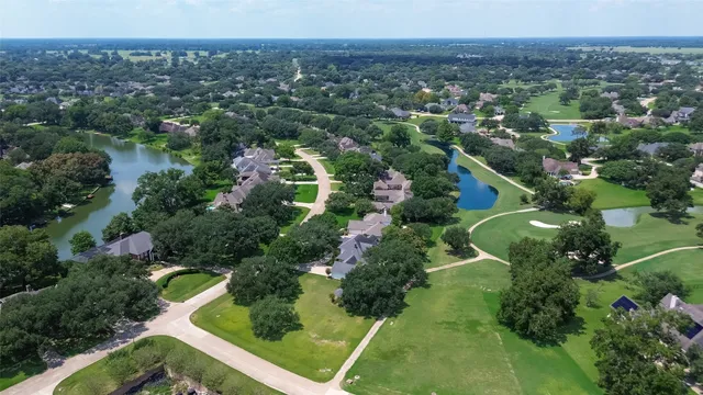 an aerial view of green landscape with trees houses and mountain view