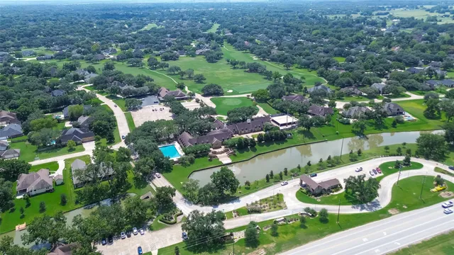 an aerial view of a house with a garden and swimming pool
