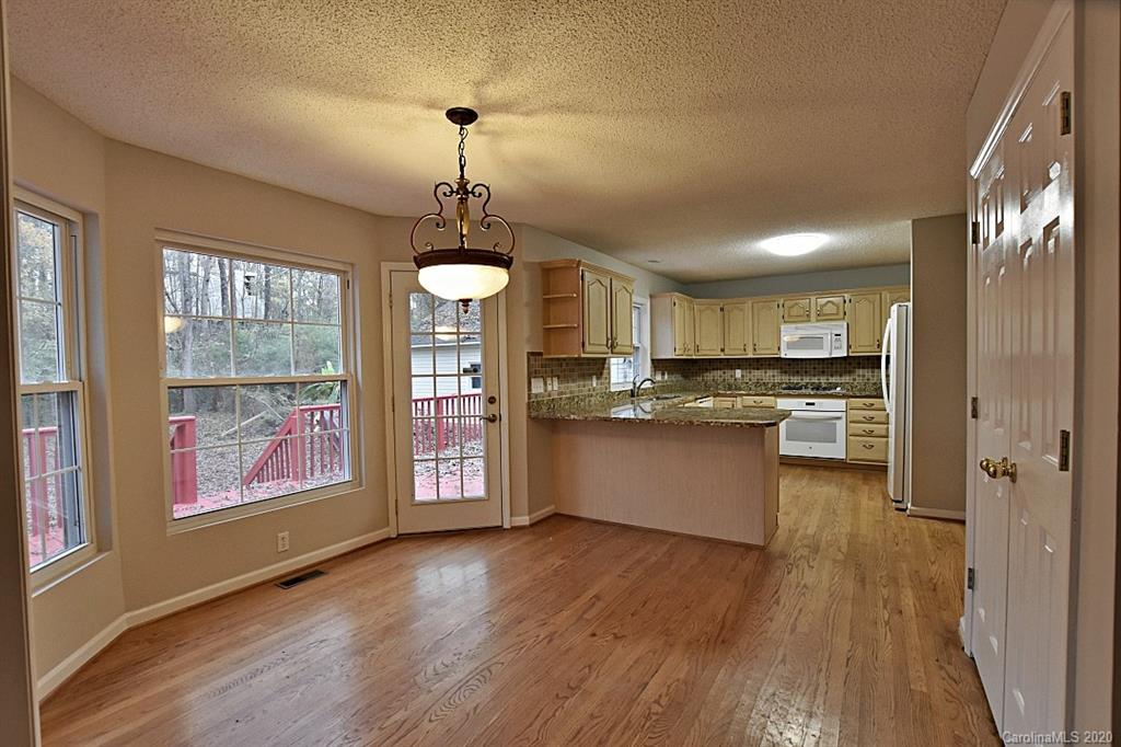 13022 Hamilton Pl Drive Fort Mill, SC 29708 - Photo 17 of 31 a large kitchen with stainless steel appliances granite countertop a large window and wooden floor