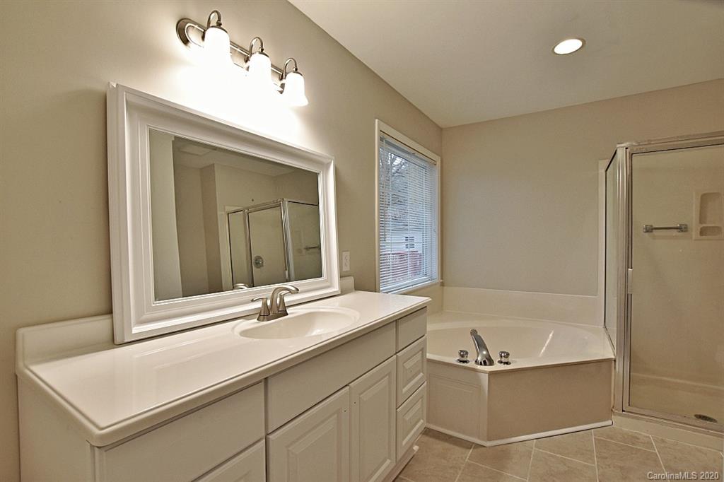 13022 Hamilton Pl Drive Fort Mill, SC 29708 - Photo 20 of 31 a bathroom with a tub sink and mirror