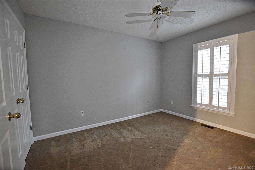 13022 Hamilton Pl Drive Fort Mill, SC 29708 - Photo 23 of 31 an empty room with chandelier fan and windows