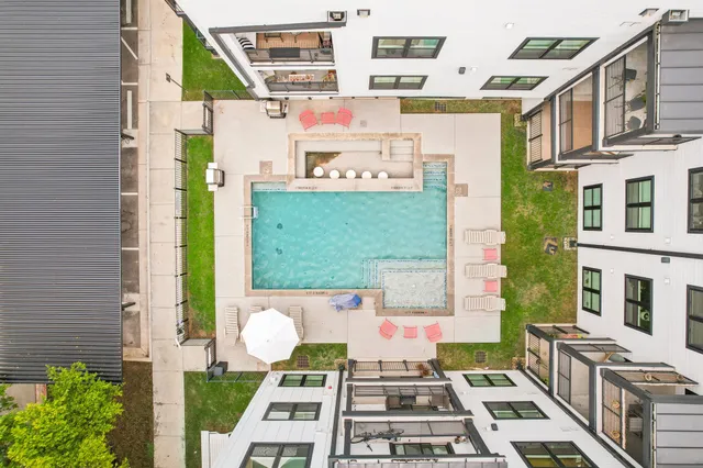 a front view of a house with a garden and garage