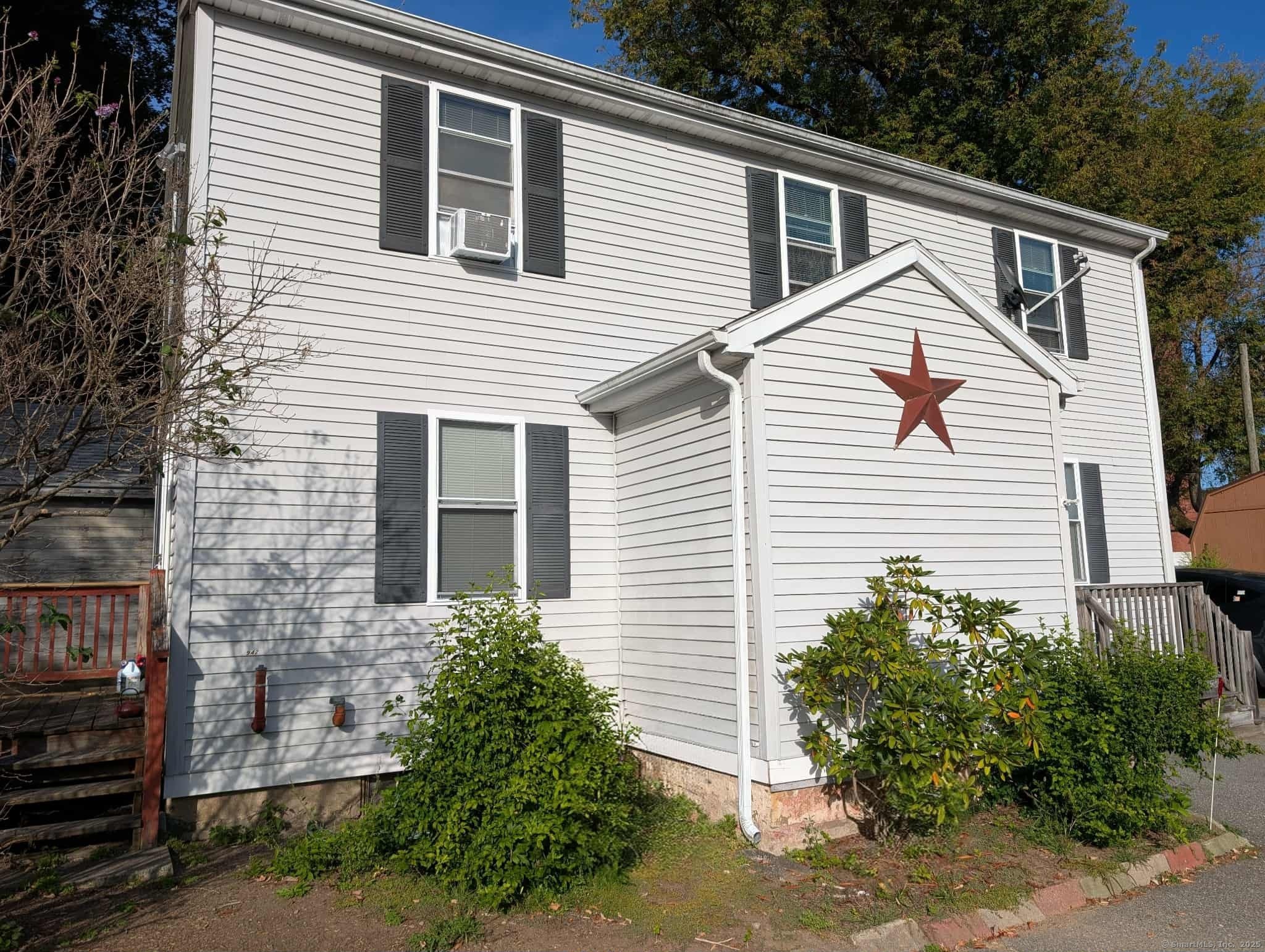 a view of a house with a yard and plants