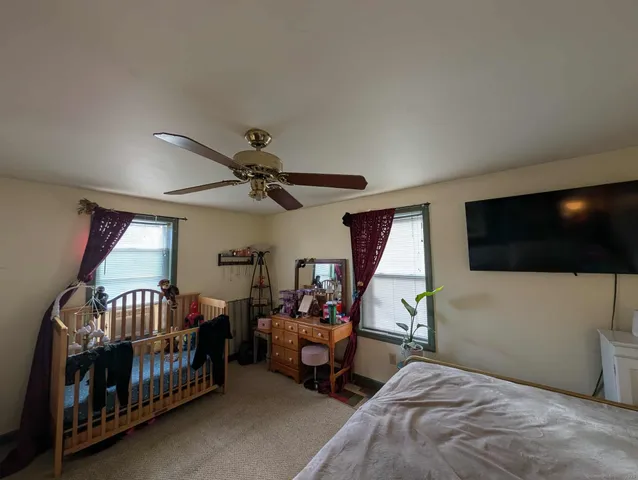 a bedroom with furniture and a flat screen tv