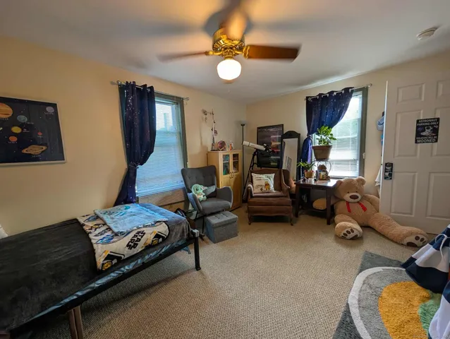 a bedroom with bed and a window