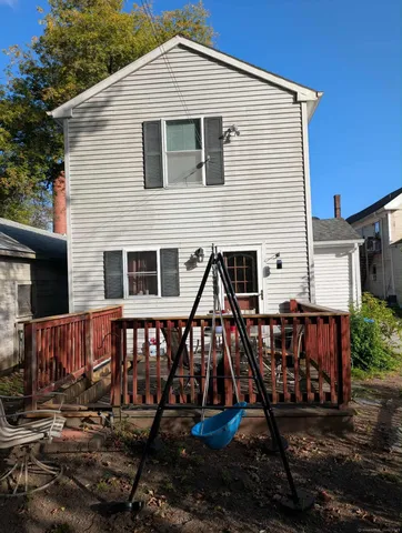 a view of a house with backyard and deck