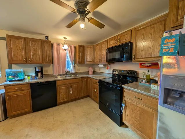 a kitchen with stainless steel appliances granite countertop a stove top oven a sink dishwasher and a microwave