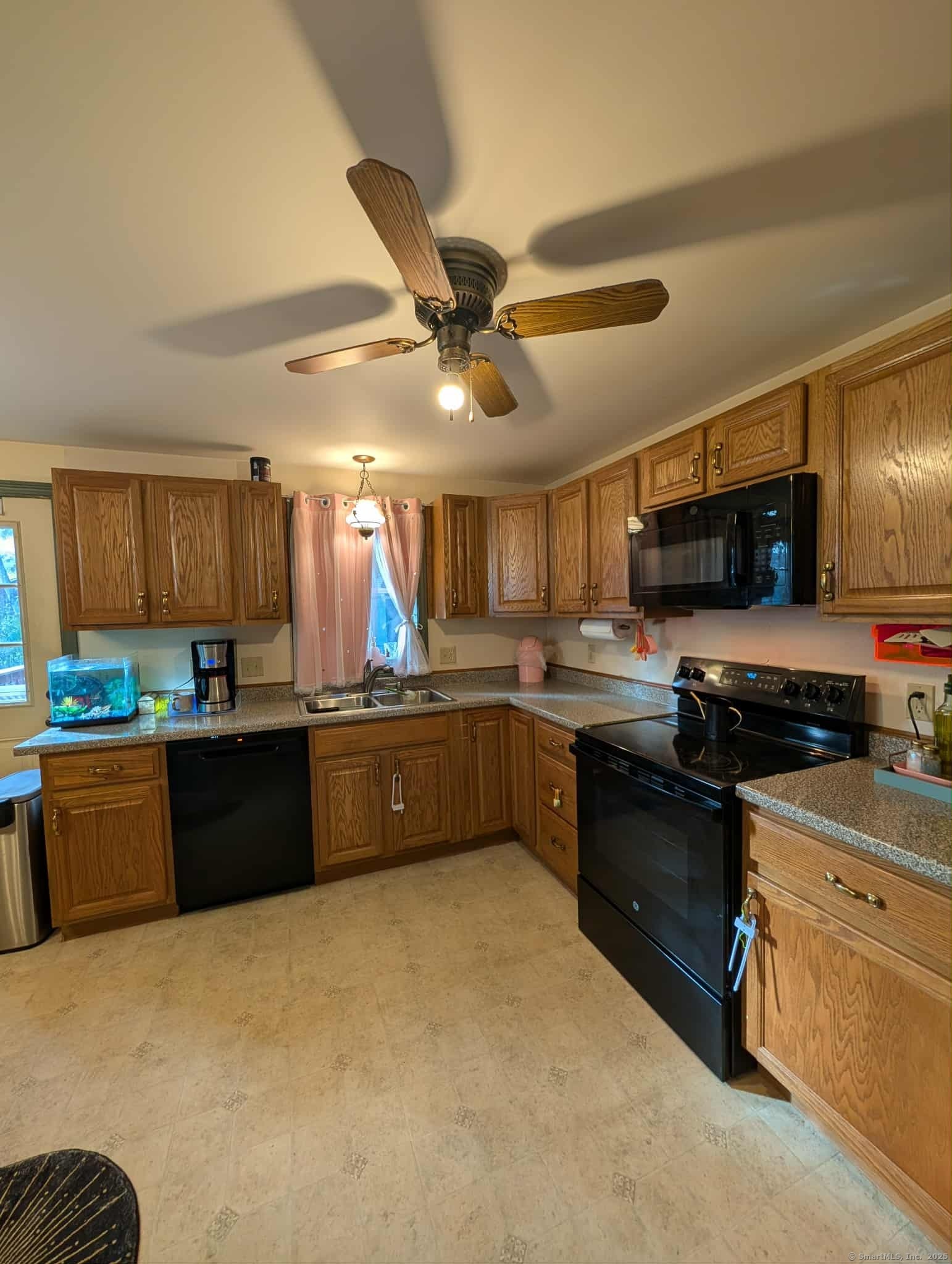 942 Riverside Drive Thompson, CT 06255 - Photo 6 of 21 a kitchen with stainless steel appliances granite countertop a sink a stove top oven a chimney cabinets and a refrigerator