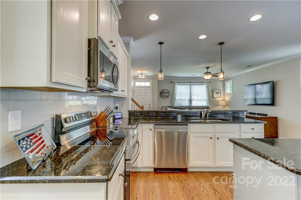 3558 Richard's Crossing Fort Mill, SC 29708 - Photo 13 of 35 a kitchen with stainless steel appliances granite countertop a sink and a stove