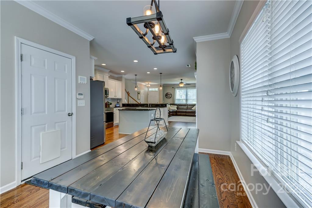 3558 Richard's Crossing Fort Mill, SC 29708 - Photo 16 of 35 a dining room with stainless steel appliances furniture or kitchen view and a chandelier