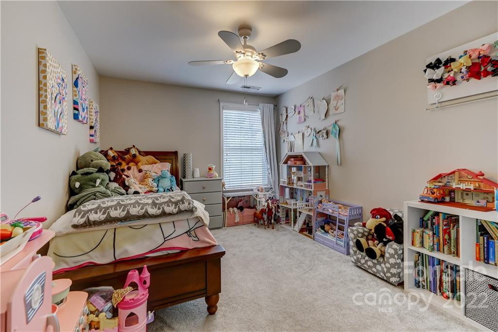 3558 Richard's Crossing Fort Mill, SC 29708 - Photo 25 of 35 a bedroom with furniture and a chandelier