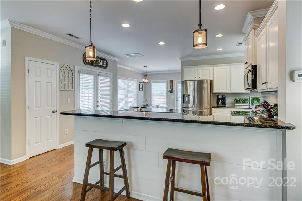 3558 Richard's Crossing Fort Mill, SC 29708 - Photo 10 of 35 a kitchen with stainless steel appliances a table chairs refrigerator and microwave
