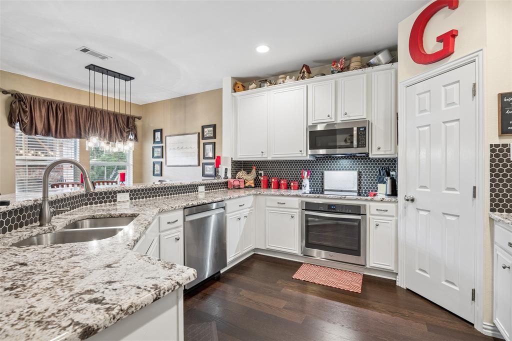 403 Springtree Road Lake Dallas, TX 75065 - Photo 13 of 34 a kitchen with granite countertop a sink and a stove top oven