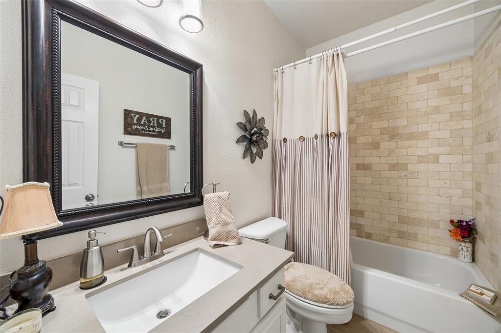 403 Springtree Road Lake Dallas, TX 75065 - Photo 17 of 34 a bathroom with a sink a toilet and shower