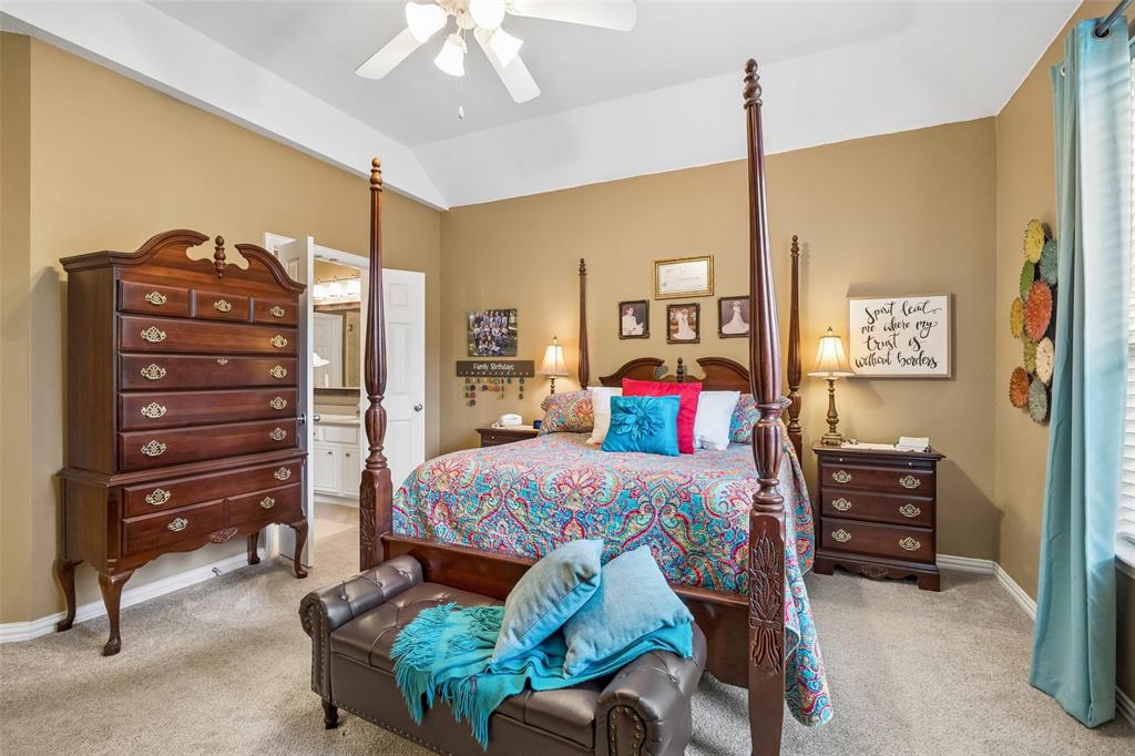 403 Springtree Road Lake Dallas, TX 75065 - Photo 19 of 34 a bedroom with a bed a dresser and a chandelier