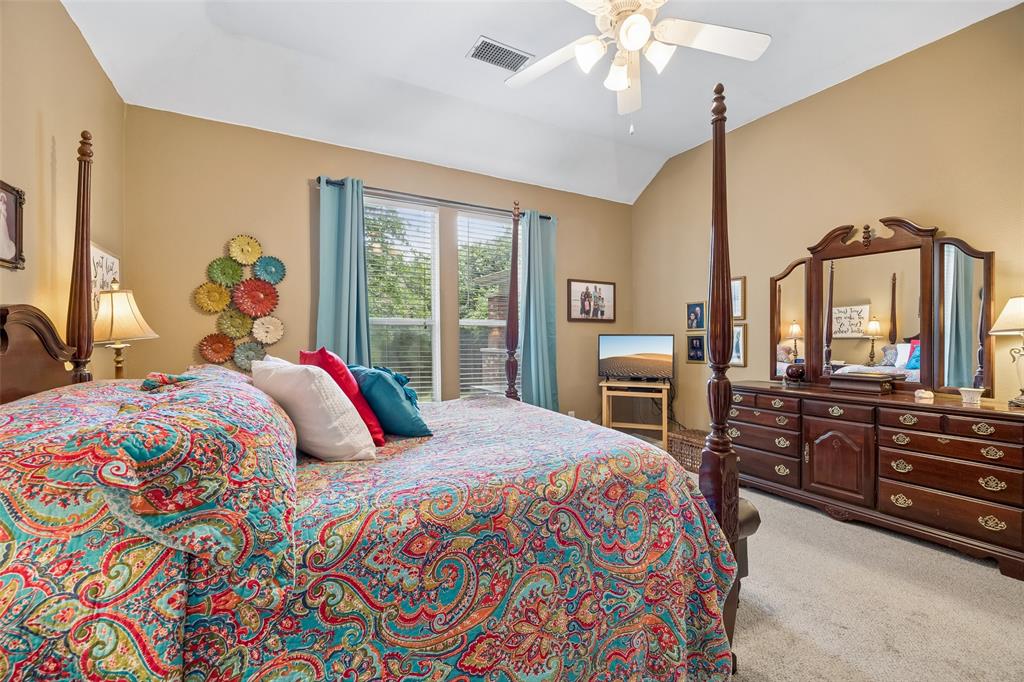 403 Springtree Road Lake Dallas, TX 75065 - Photo 20 of 34 a bedroom with a bed a dresser and flat screen tv