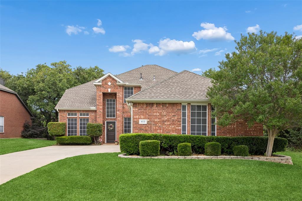 403 Springtree Road Lake Dallas, TX 75065 - Photo 2 of 34 a front view of a house with a yard and garage