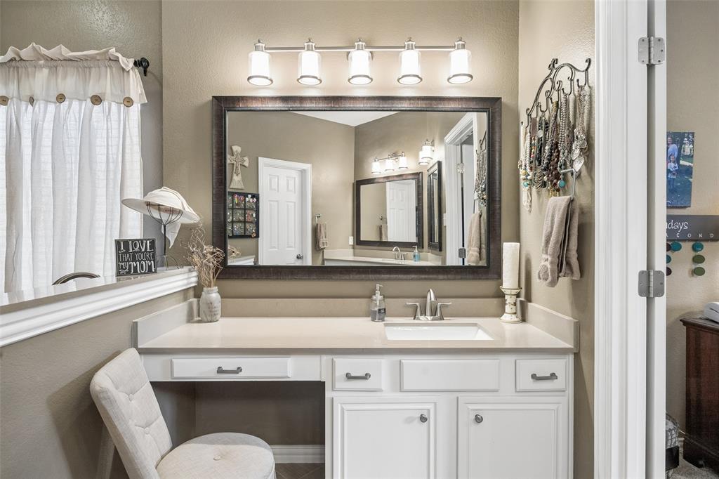 403 Springtree Road Lake Dallas, TX 75065 - Photo 22 of 34 a en suite bathroom with a toilet sink and mirror