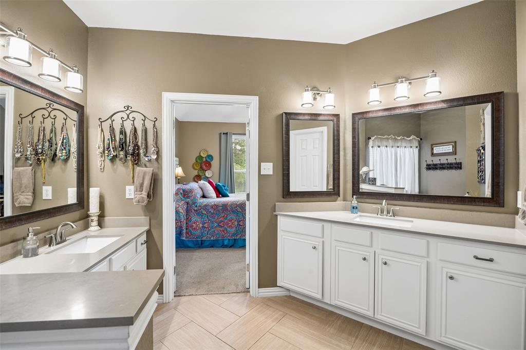 403 Springtree Road Lake Dallas, TX 75065 - Photo 23 of 34 a en suite bathroom with a double vanity sink a mirror and a shower