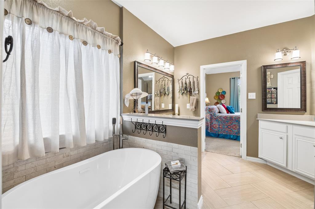 403 Springtree Road Lake Dallas, TX 75065 - Photo 24 of 34 a living room with a bed and a large mirror