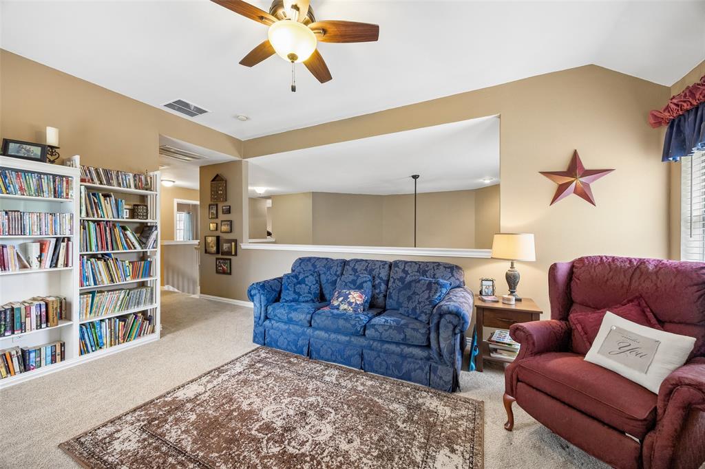 403 Springtree Road Lake Dallas, TX 75065 - Photo 26 of 34 a living room with furniture and a book shelf