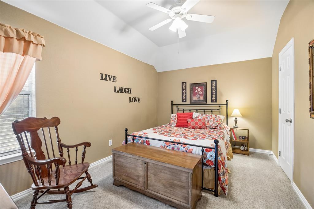 403 Springtree Road Lake Dallas, TX 75065 - Photo 28 of 34 a bedroom with a bed and a chandelier