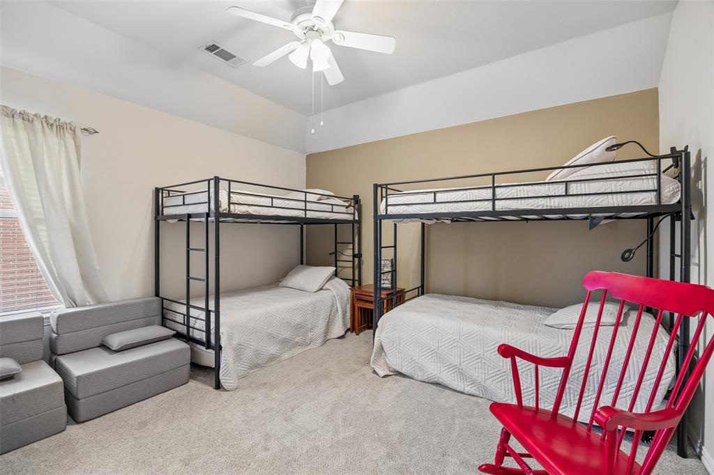 403 Springtree Road Lake Dallas, TX 75065 - Photo 30 of 34 a bedroom with a bed and a chandelier