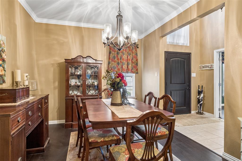 403 Springtree Road Lake Dallas, TX 75065 - Photo 3 of 34 a view of a dining room with furniture and chandelier