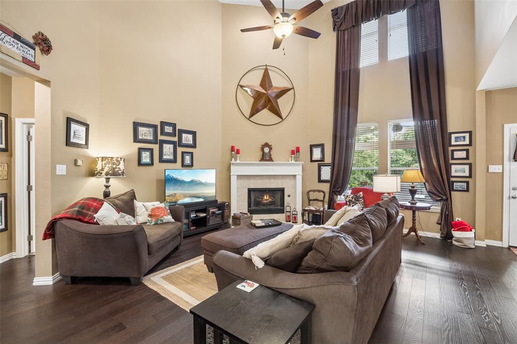 403 Springtree Road Lake Dallas, TX 75065 - Photo 7 of 34 a living room with fireplace furniture and a large window