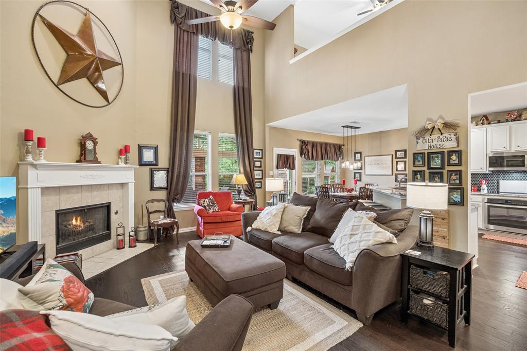 403 Springtree Road Lake Dallas, TX 75065 - Photo 8 of 34 a living room with furniture a fireplace and a chandelier