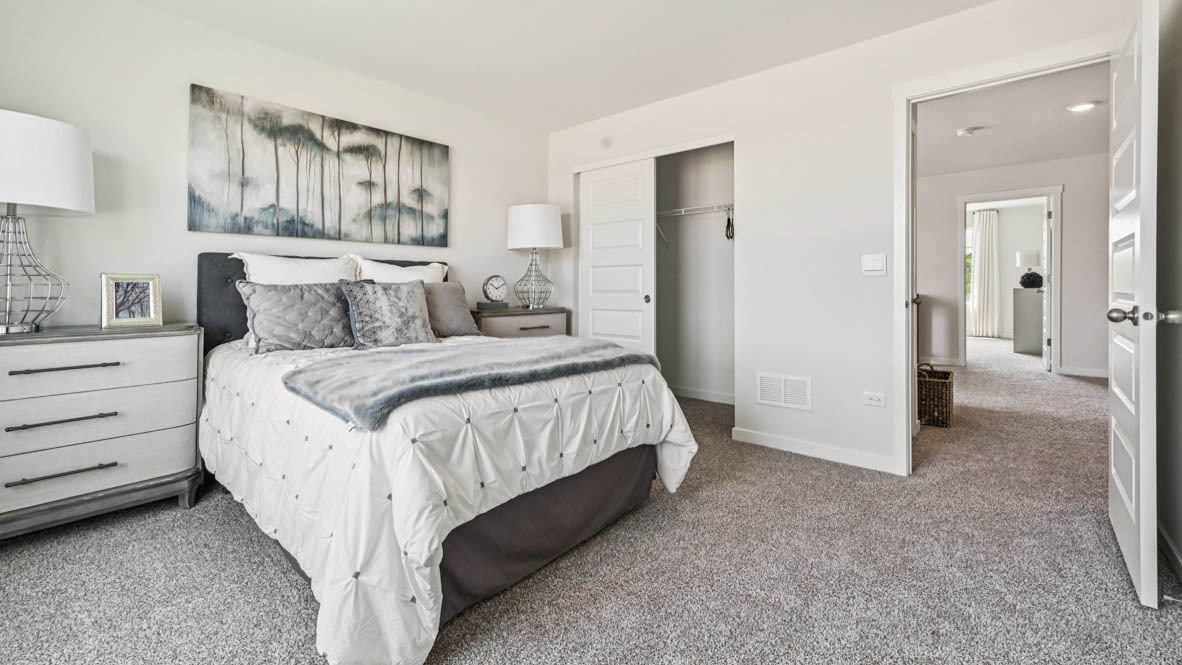 2311 Hirsch Road Oswego, IL 60543 - Photo 36 of 40 a bed room with a bed and a mirror