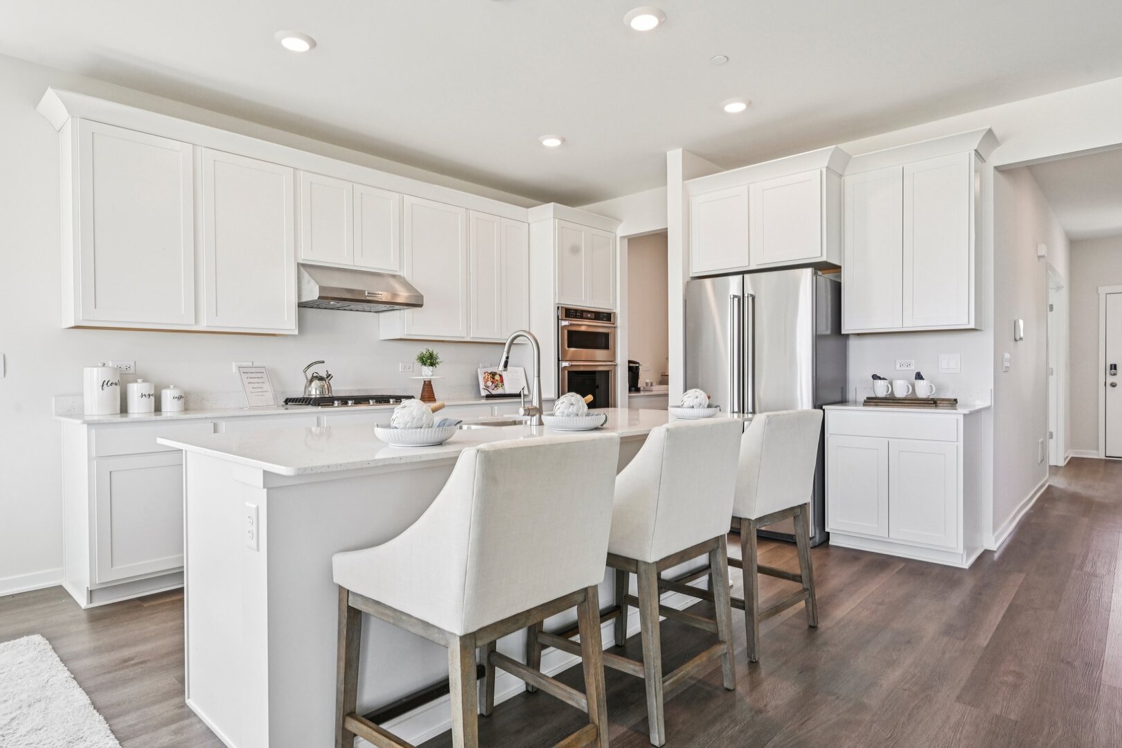 2311 Hirsch Road Oswego, IL 60543 - Photo 8 of 40 a kitchen with stainless steel appliances a white refrigerator a sink a stove a dining table and chairs
