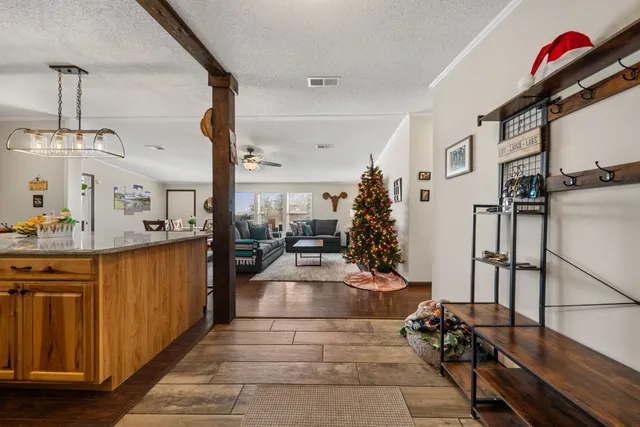 a kitchen with stainless steel appliances granite countertop a sink a stove and a wooden floors