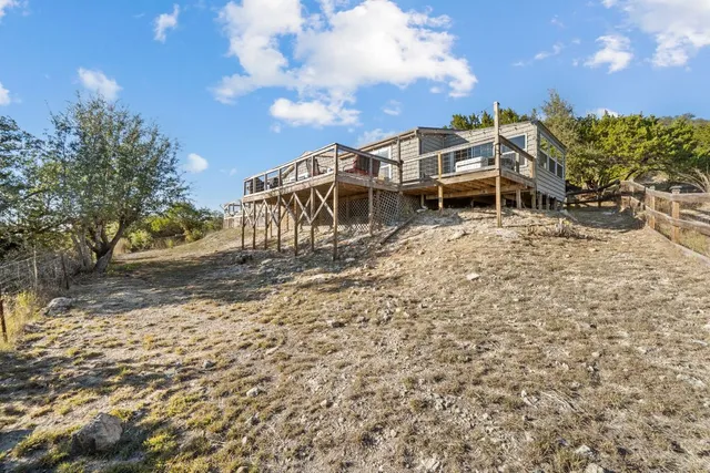 a bathroom with a shower a mirror and a sink