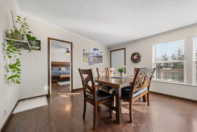 a dining room with furniture and wooden floor