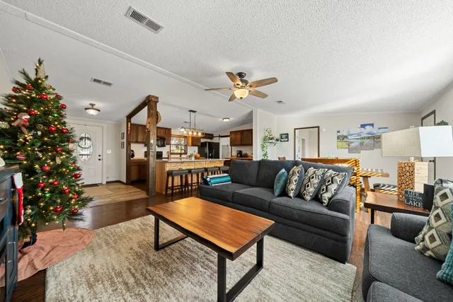 a living room with furniture flower pot and a table