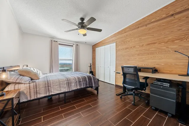 a bedroom with a bed and a desk