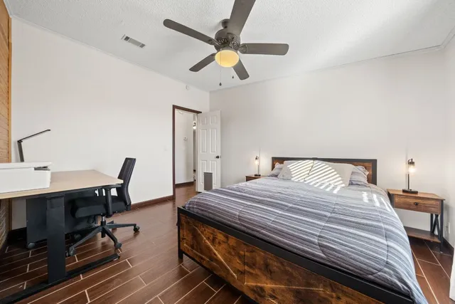 a bedroom with a bed a desk and chair