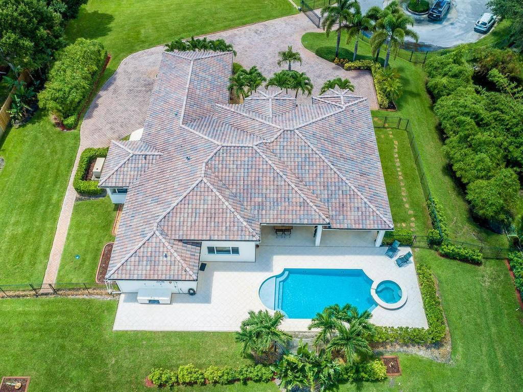 16500 Southwest 62nd Street Southwest Ranches, FL 33331 - Photo 12 of 100 an aerial view of a house with swimming pool and garden
