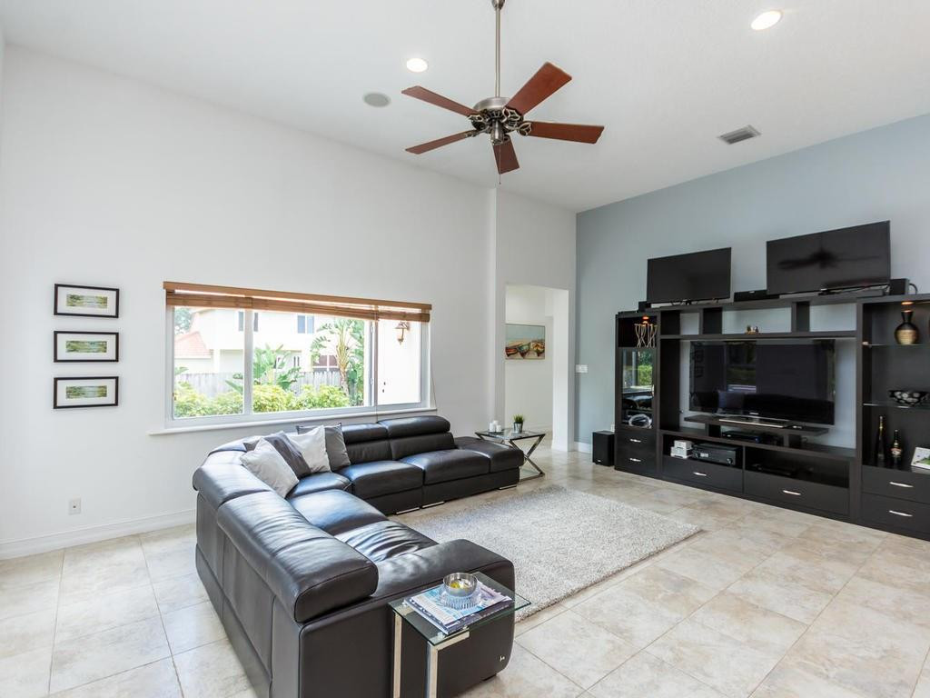 16500 Southwest 62nd Street Southwest Ranches, FL 33331 - Photo 29 of 100 a living room with furniture a ceiling fan and a flat screen tv