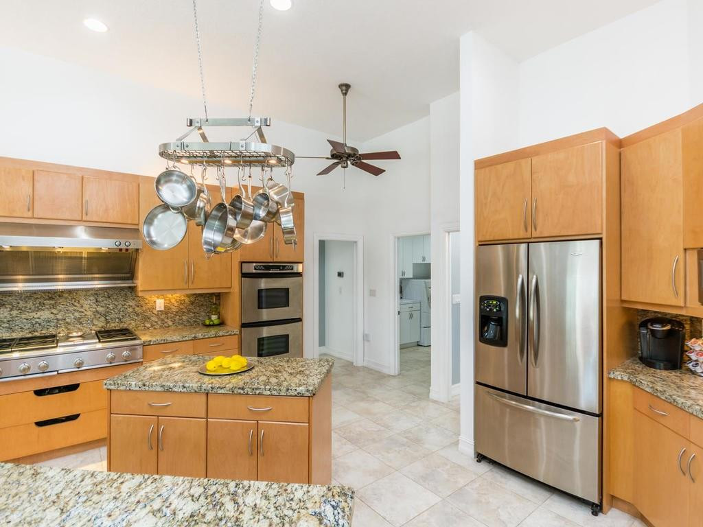 16500 Southwest 62nd Street Southwest Ranches, FL 33331 - Photo 35 of 100 a kitchen with stainless steel appliances granite countertop a refrigerator a stove and a sink with wooden floor