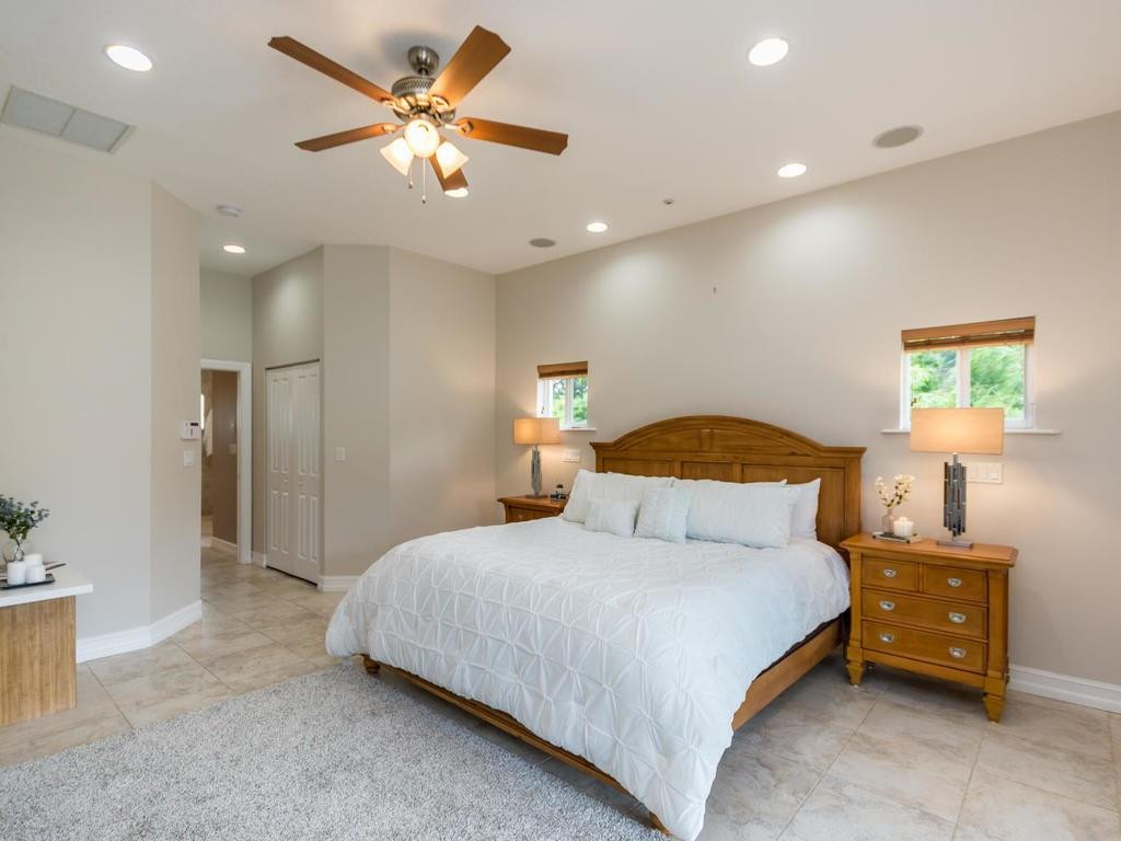16500 Southwest 62nd Street Southwest Ranches, FL 33331 - Photo 45 of 100 a bedroom with a bed and a chandelier