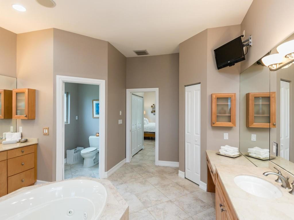 16500 Southwest 62nd Street Southwest Ranches, FL 33331 - Photo 53 of 100 a spacious bathroom with a granite countertop sink and a mirror