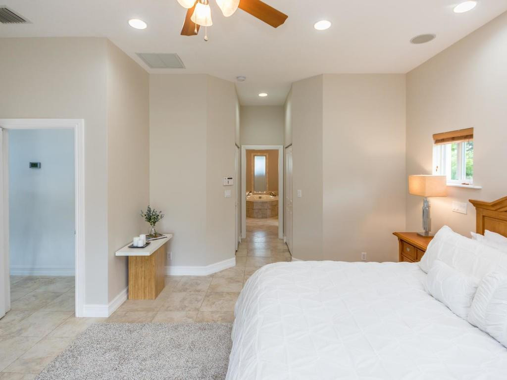 16500 Southwest 62nd Street Southwest Ranches, FL 33331 - Photo 55 of 100 a bedroom with a bed and a chandelier