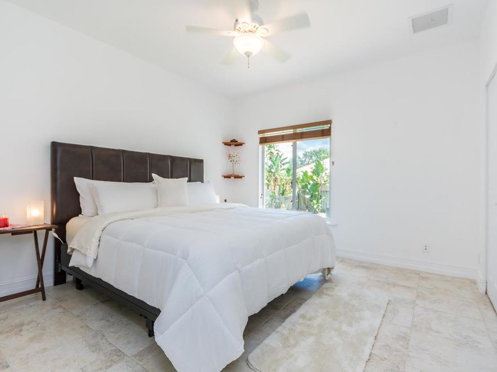 16500 Southwest 62nd Street Southwest Ranches, FL 33331 - Photo 59 of 100 a bedroom with a bed and a window