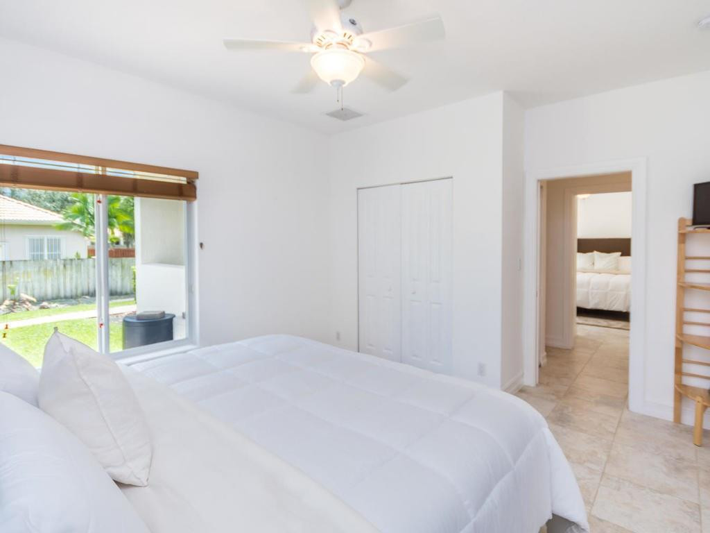 16500 Southwest 62nd Street Southwest Ranches, FL 33331 - Photo 60 of 100 a bedroom with a bed and a large window
