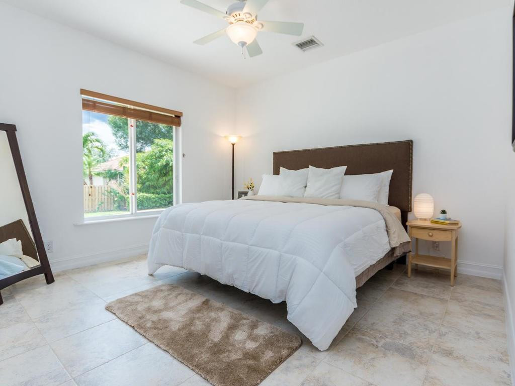 16500 Southwest 62nd Street Southwest Ranches, FL 33331 - Photo 63 of 100 a bedroom with a bed and a large window