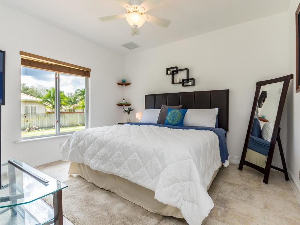 16500 Southwest 62nd Street Southwest Ranches, FL 33331 - Photo 64 of 100 a bedroom with a bed and a window
